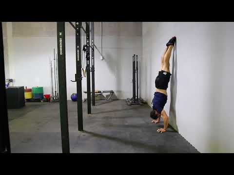 Headstand Push-Up (Wall-Assisted)
