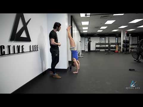 Handstand Push-Up (Wall Assisted, Eccentric)